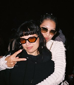 Two friends at a live music event.